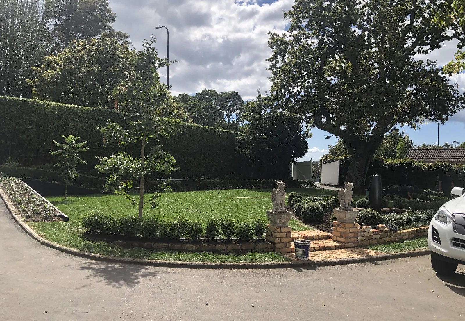 Large formal grounds — clipped hedging around an open lawn and sealed drive